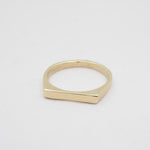 Gold ring on a light gray background