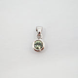 A sterling silver pendant featuring a bezel-set round light green gemstone, shown against a plain light gray background.