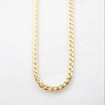 Gold chain on a light gray background