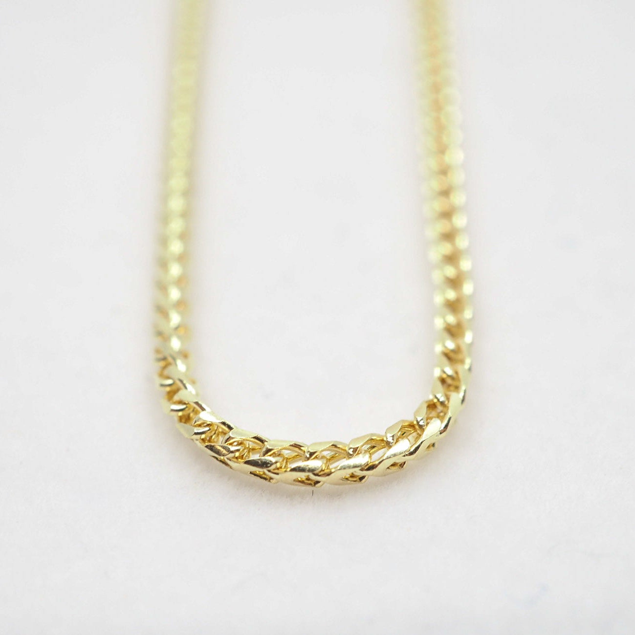 Gold chain necklace on a white background