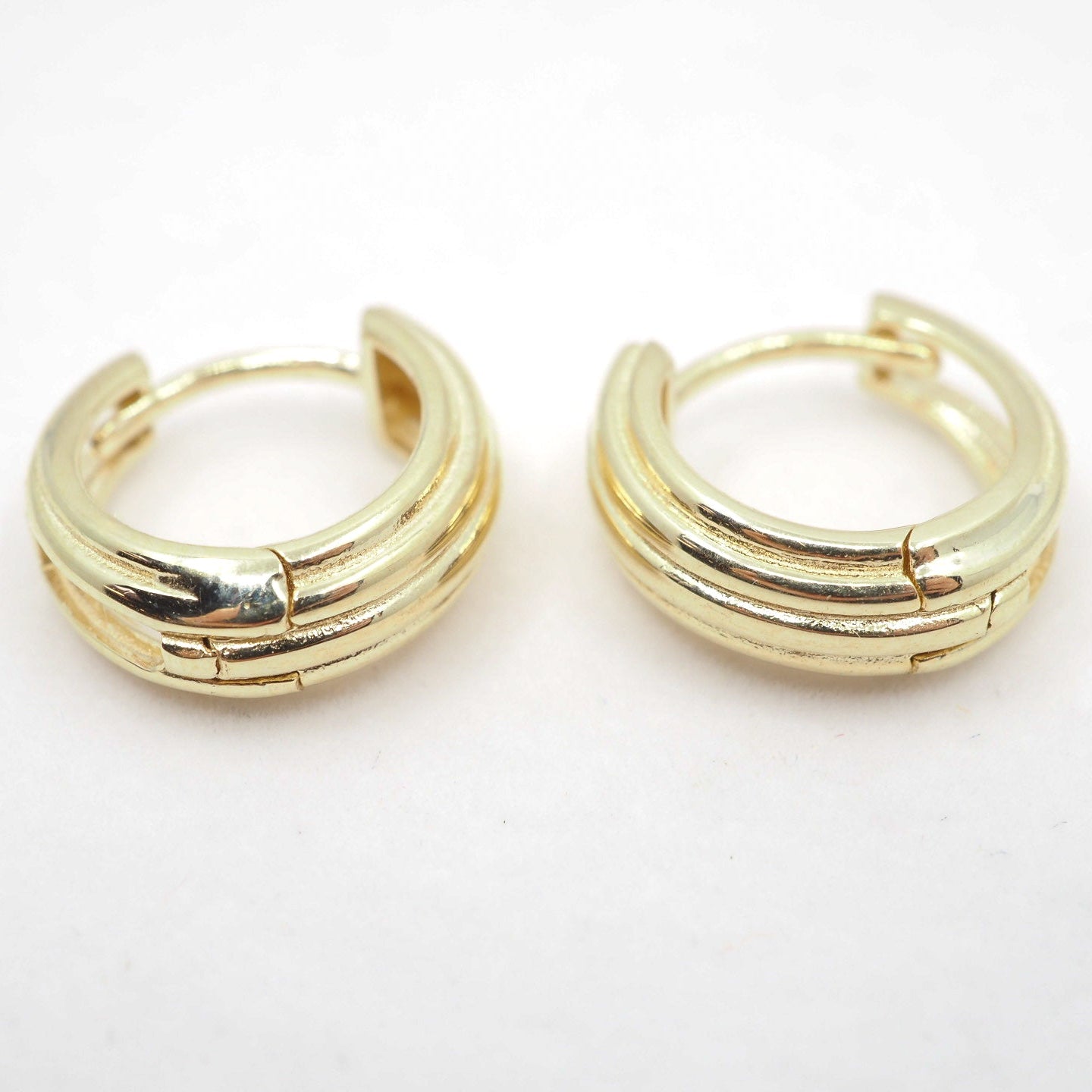 Pair of gold hoop earrings on a white background