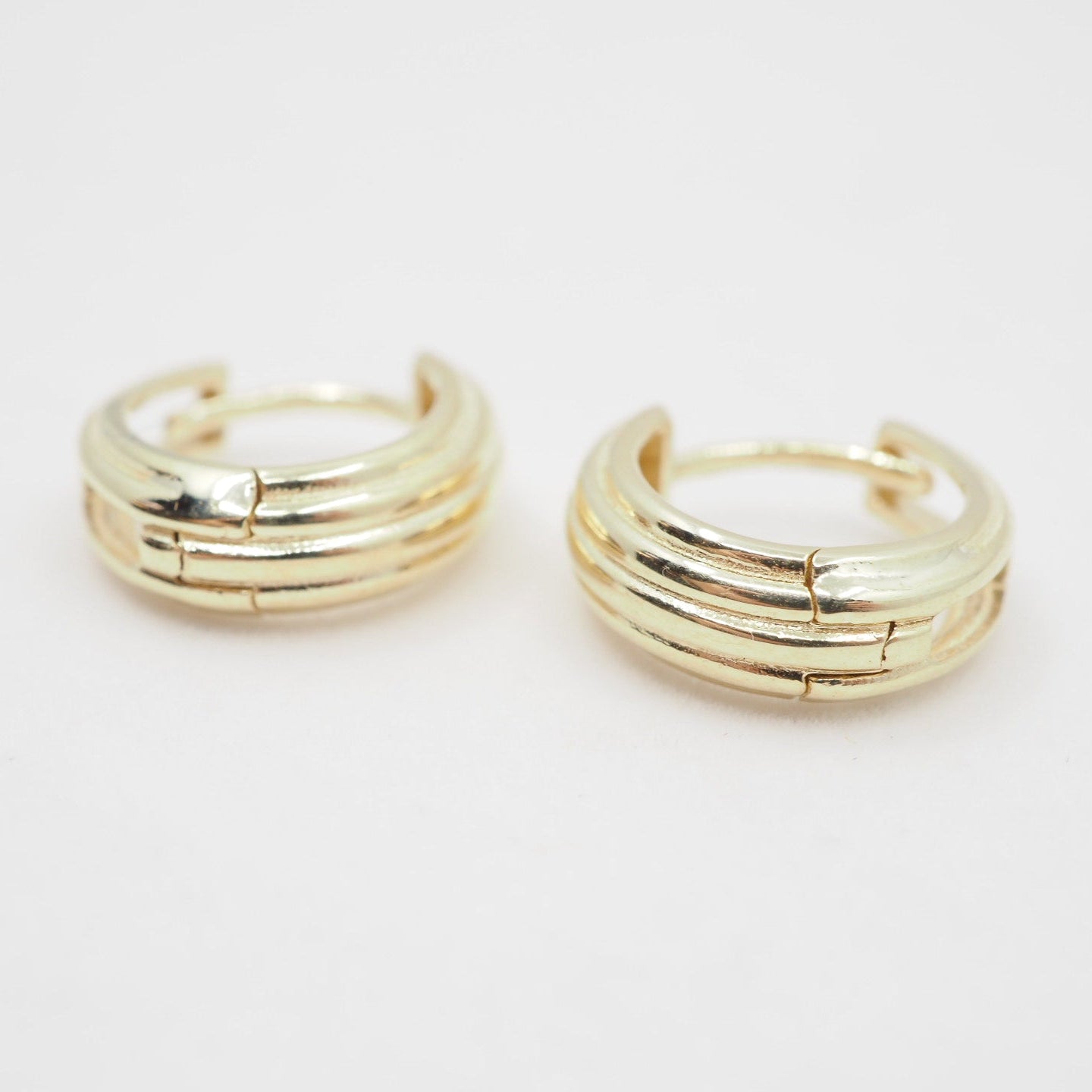 Pair of gold hoop earrings on a white background