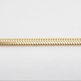 Gold chain on a light gray background
