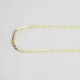 Gold chain on a light gray background