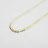 Gold chain necklace on a light gray background