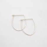 Silver hoop earrings on a light gray background