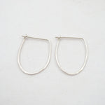 Pair of silver hoop earrings on a white background