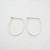 Pair of silver hoop earrings on a white background