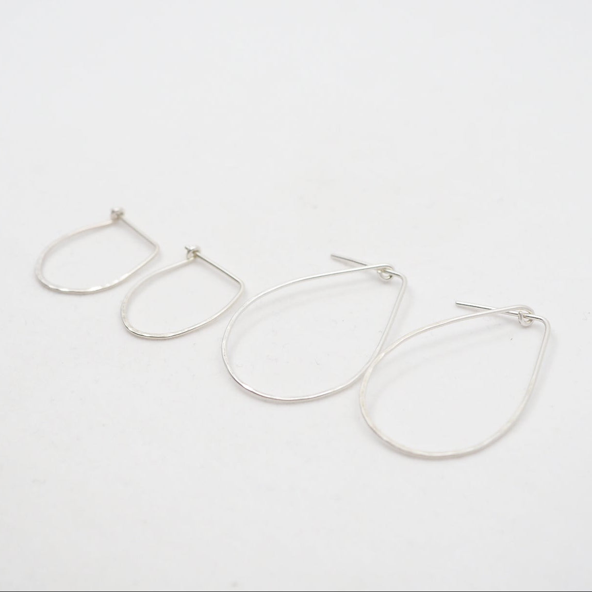 Pair of silver hoop earrings on a white background
