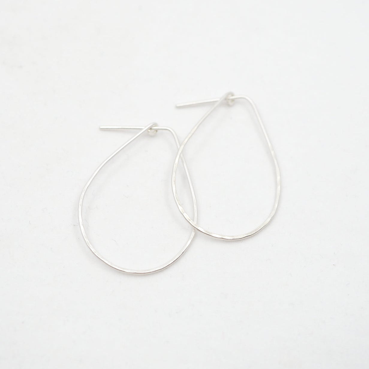 Silver hoop earrings on a white background