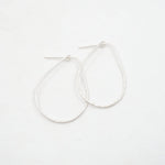Silver hoop earrings on a white background