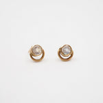Pair of gold earrings with gemstones on a white background