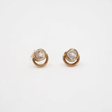Pair of gold earrings with gemstones on a white background