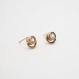 Gold earrings with gemstones on a white background
