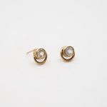 Pair of gold earrings with moonstone gemstones on a white background