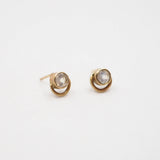 Pair of gold earrings with moonstone gemstones on a white background