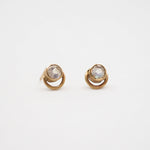 Pair of gold earrings with moonstones on a white background