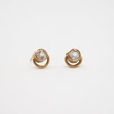 Pair of gold earrings with moonstones on a white background