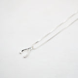 Silver necklace with a wishbone pendant on a light gray background