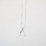 Silver wishbone necklace on a white background