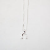 Silver wishbone necklace on a white background