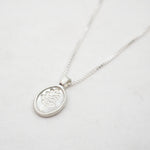 Silver necklace with a lupine pendant on a white background