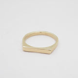 Gold ring on a light gray background