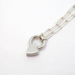 Silver heart-shaped keychain on a white background
