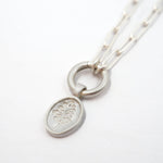 Silver necklace with the Lupine pendant on a white background