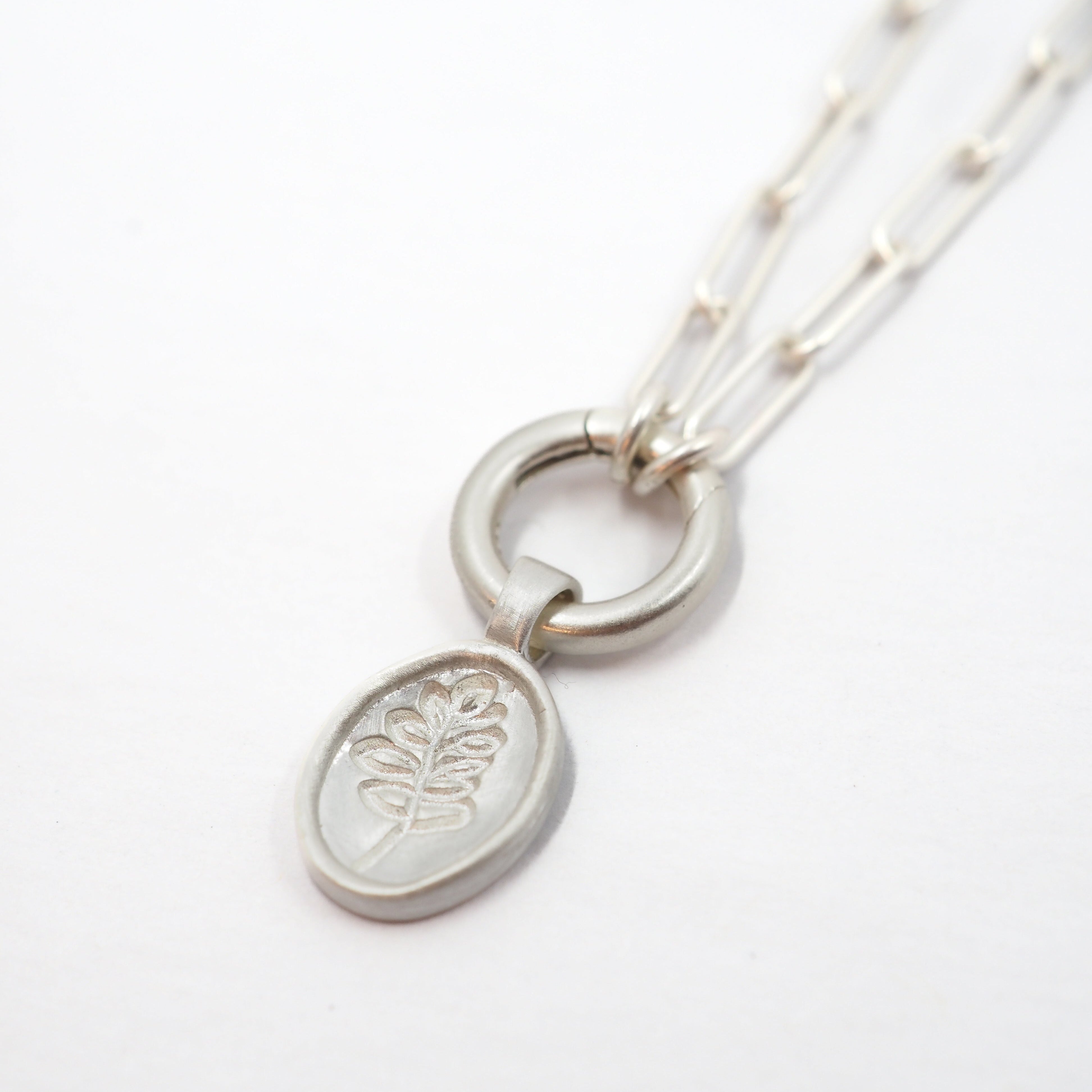 Silver necklace with the Lupine pendant on a white background