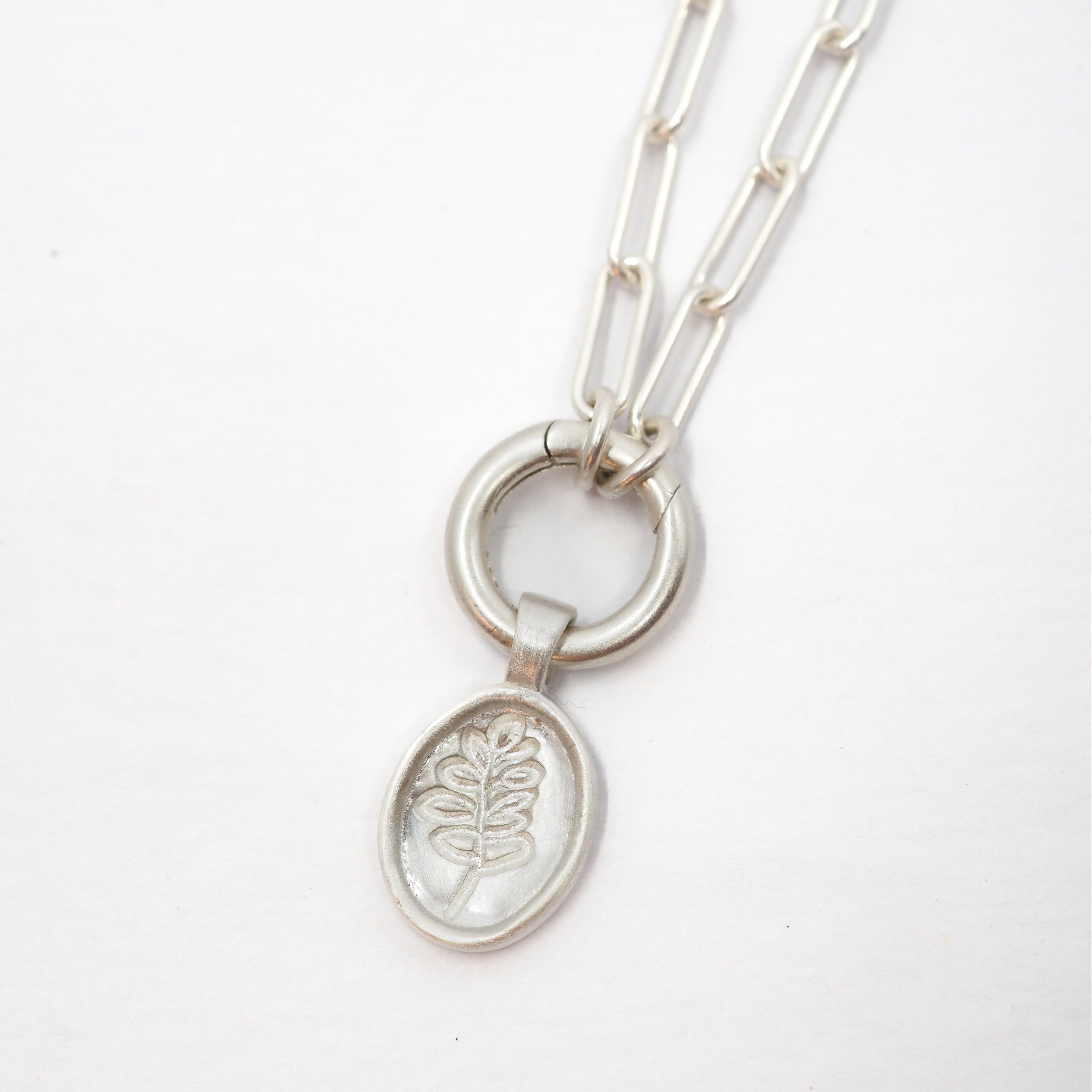 Silver necklace with the Lupine pendant on a white background