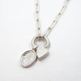 Silver necklace with a heart-shaped pendant and the Lupine pendant on a white background