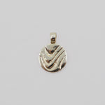 Gold pendant with wavy design on a light gray background
