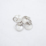 Four textured silver disc charms with attached jump rings, displayed on a clean white background.