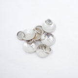 A cluster of hammered silver disc with the letter F charms with attached jump rings, displayed on a clean white background.