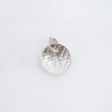 A small hammered silver pendant charm with a textured, organic surface and a top loop, shown on a plain white background.