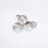 Four textured silver jewelry findings, including two round disc charms with loops and two flat round bases with ring settings, arranged on a clean white background.