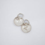 Two textured sterling silver disc charms with engraved letter Z and attached jump rings, displayed on a clean white background.