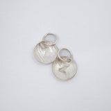 Two textured sterling silver disc charms with engraved letter Z and attached jump rings, displayed on a clean white background.