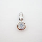 A sterling silver pendant charm featuring a bezel-set round iridescent moonstone gemstone, shown on a plain white background.