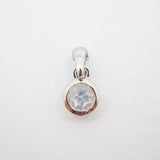 A sterling silver pendant charm featuring a bezel-set round iridescent moonstone gemstone, shown on a plain white background.