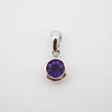 A sterling silver pendant charm featuring a round-cut purple gemstone in a bezel setting, shown on a plain white background.