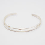 Silver bangle on a light gray background