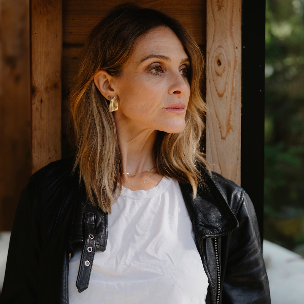 Woman looking to the side with gold earrings