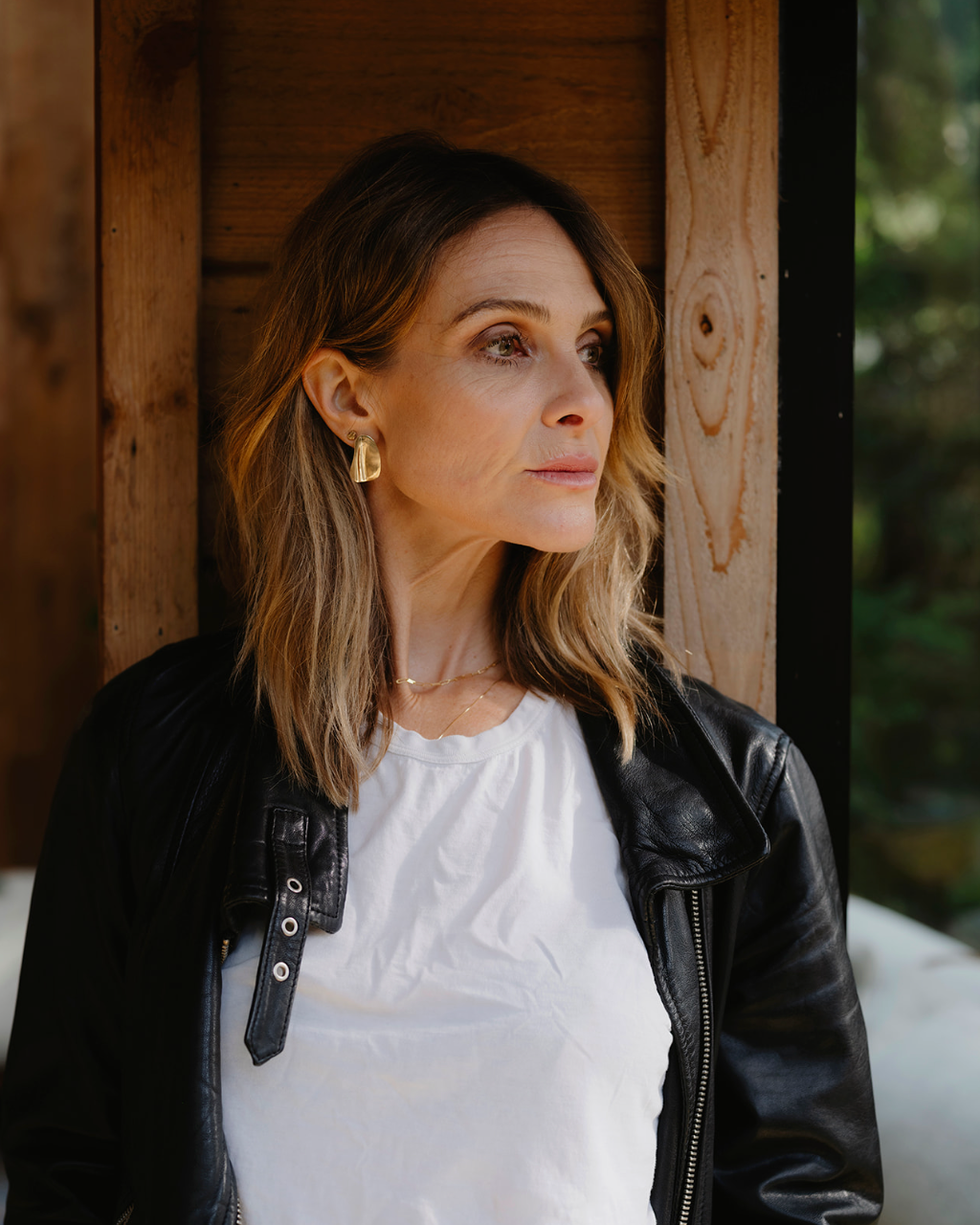 Woman looking to the side with gold earrings