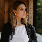 Woman looking to the side with gold earrings