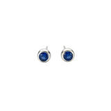 Silver earrings with blue gemstones on a light gray background